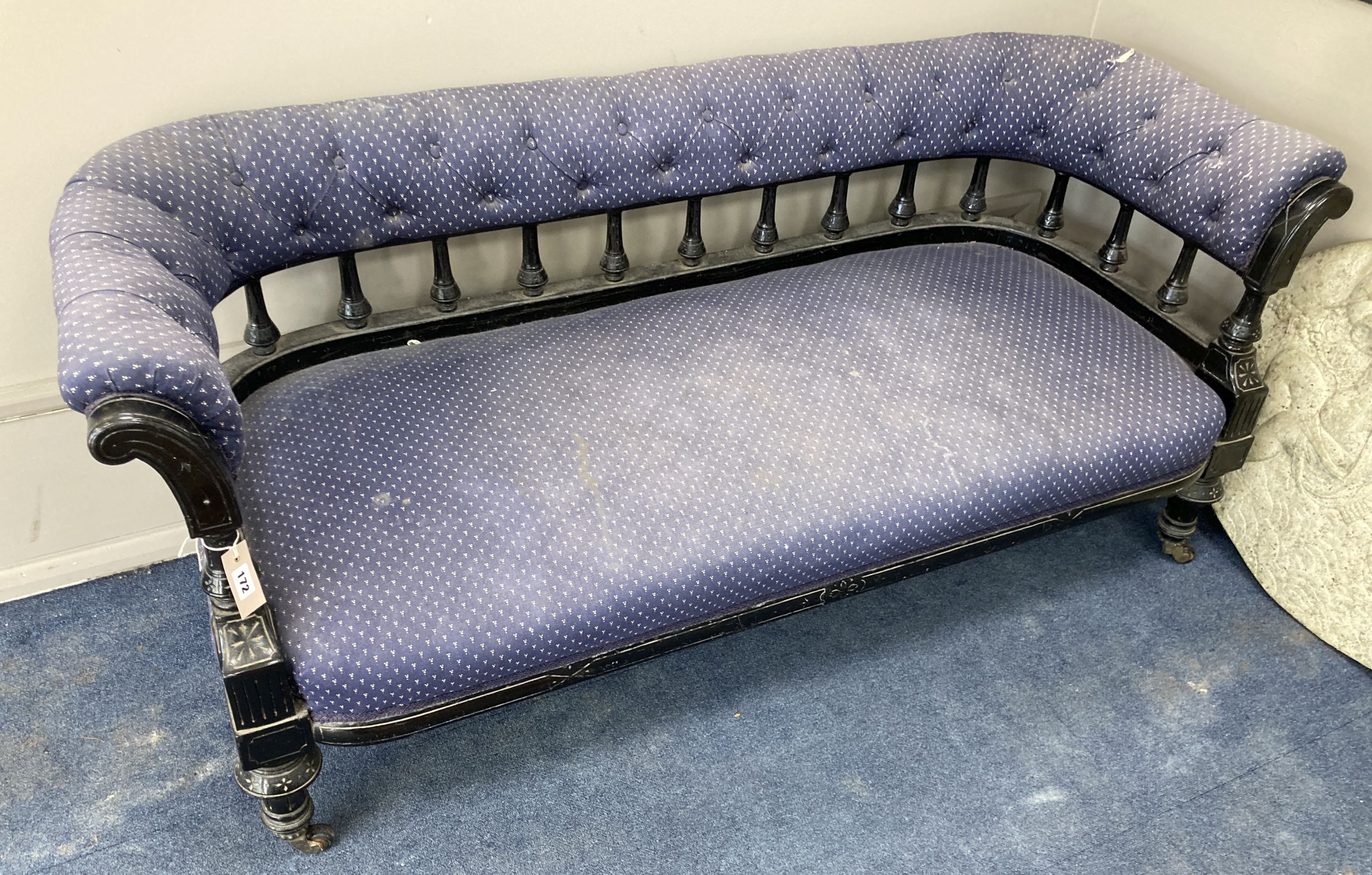 A late Victorian ebonised tub framed settee, length 154cm, depth 56cm, height 66cm